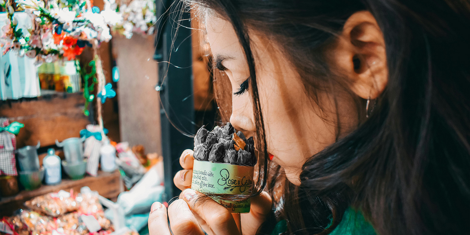 Life without Smell, illustrated by an image of a woman smelling a bundle of cloves but they're gray as she can't smell them